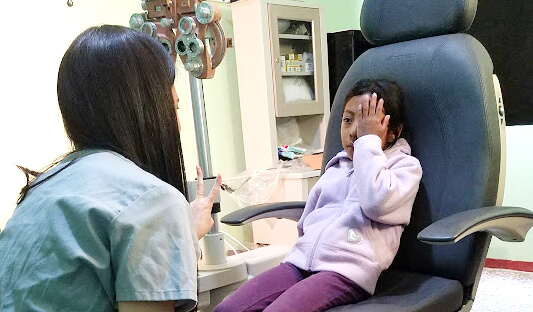 doctor checking child eyes at Missouri Eye Consultants