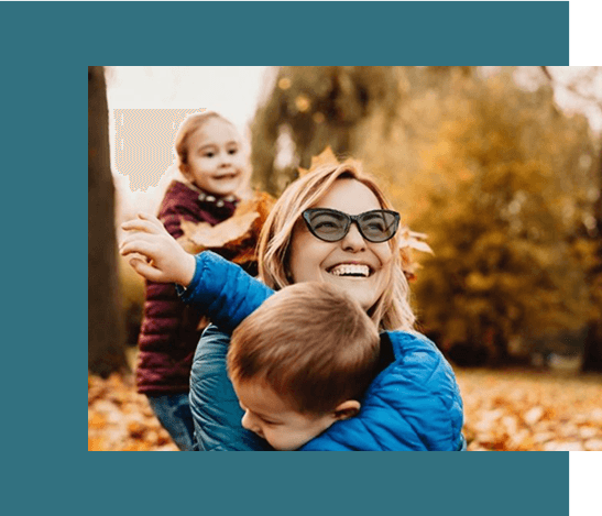 mother and child playing Mom and her kids playing in autumn leaves, wearing stylish glasses from Missouri Eye Consultants